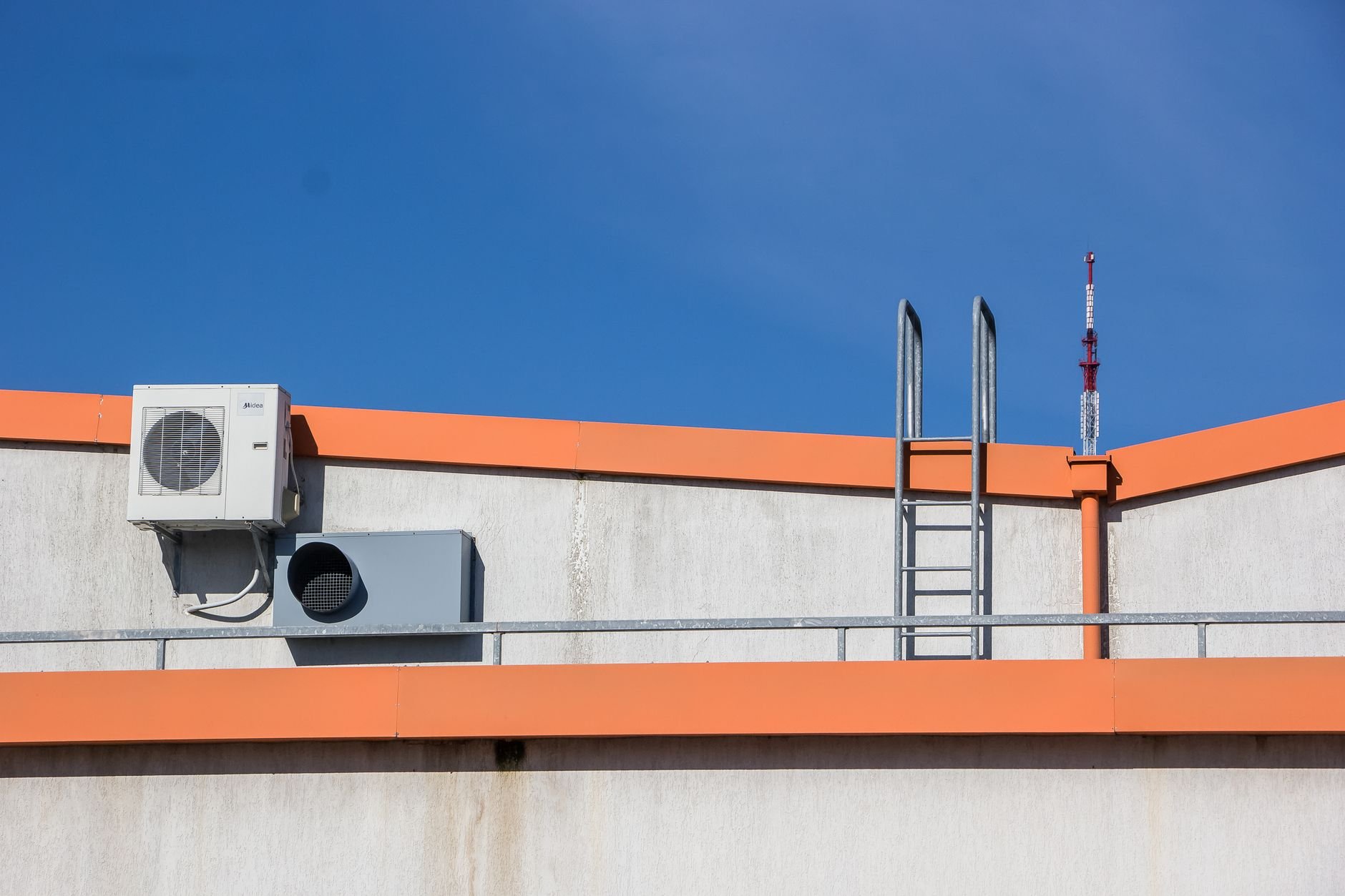 HVAC engineer on a rooftop unit at a commercial building